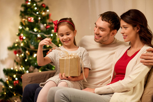 happy family with christmas present at home - Photo, image
