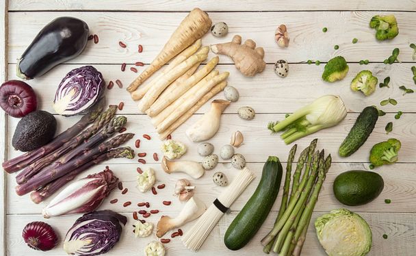 Plant based modern flat lay big set collection rows of white red purple green vegetables on white background. Asparagus, red cabbage, avocado, eggplants, onion. Healthy food concept. Overhead. Top view. - Photo, Image