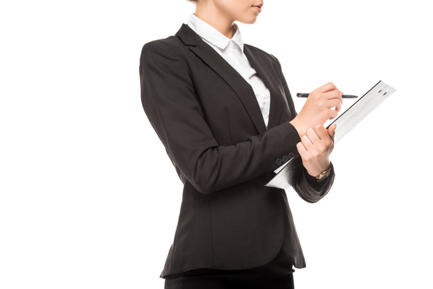 cropped shot of young businesswoman writing in clipboard isolated on white - Foto, immagini
