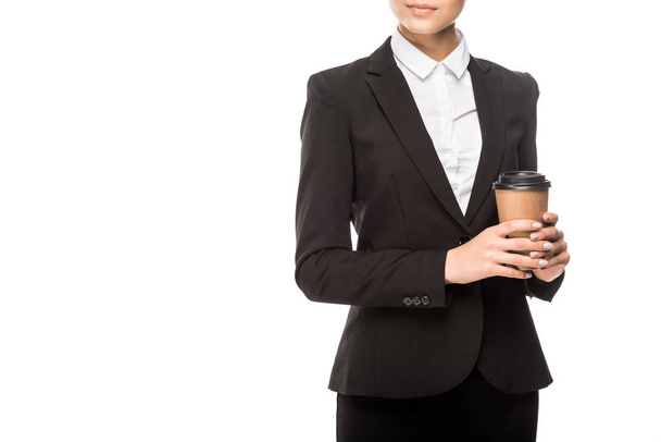 cropped shot of young businesswoman holding paper cup of coffee isolated on white - Foto, Bild