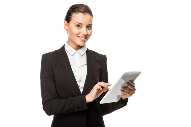 beautiful young businesswoman using tablet and looking at camera isolated on white - Φωτογραφία, εικόνα