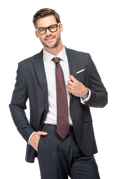 cheerful handsome young businessman in jacket and eyeglasses isolated on white - Photo, Image