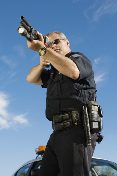 Police Officer With Gun - 写真・画像