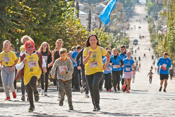 CHERNIVTSI, UKRAINE - SEPTEMBER 30 : Unidentified runners participating in the "Bukovina Mile" charity fun run on September 30, 2018 in Chernivtsi, Ukraine. - Photo, image
