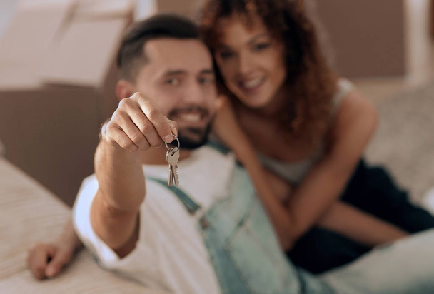young couple holding the key to a new apartment - Photo, Image