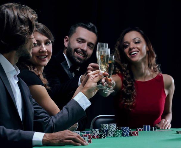 friends drinking and celebrating a gambling night - Foto, imagen