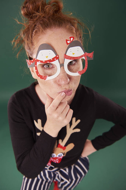 Young woman with funny christmas masks - Фото, зображення