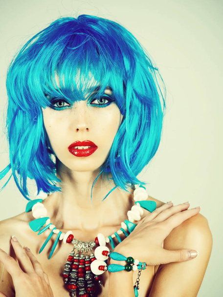 Girl with bright artificial hair in ethnic jewelry. - Photo, Image
