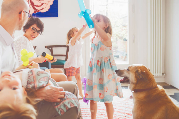 family indoor playing with balloon toys - happiness, bonding, innocence concept - Foto, imagen