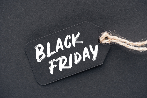 close up of sale tag with black friday sign on black - Zdjęcie, obraz