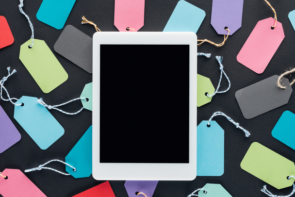 top view of digital tablet with blank screen on colorful sale tags - Photo, Image