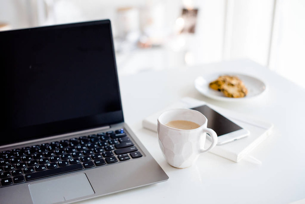Moderni valkoinen toimisto, suunnittelija käsintehty kuppi kahvia, älyfo
 - Valokuva, kuva
