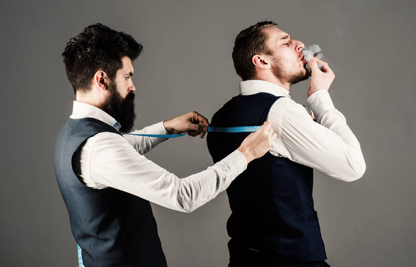 Tailor measure back for sewing suit, grey background. - Zdjęcie, obraz