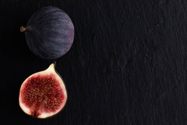 fresh ripe figs on dark background, top view with copy space. - Φωτογραφία, εικόνα