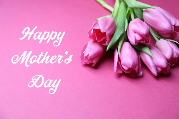 Beautiful tulips and greeting Happy Mother's Day on color background - Foto, Imagem