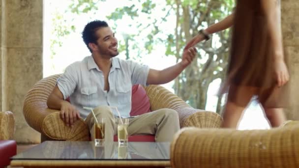 young just married hispanic couple sitting on armchair in hotel bar and hugging - Filmmaterial, Video