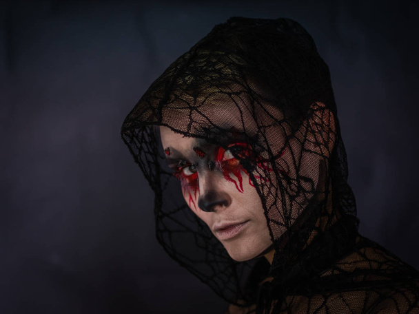 Day of the dead. Halloween. Makeup for Halloween. Portrait of a girl with bleeding eyes. - Foto, Imagem