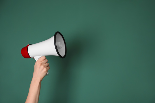 Woman holding megaphone on color background - Photo, Image