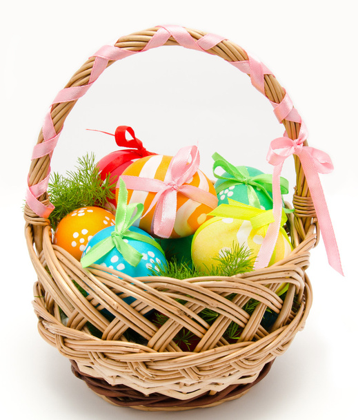 Colorful painted easter eggs in basket isolated - Foto, afbeelding