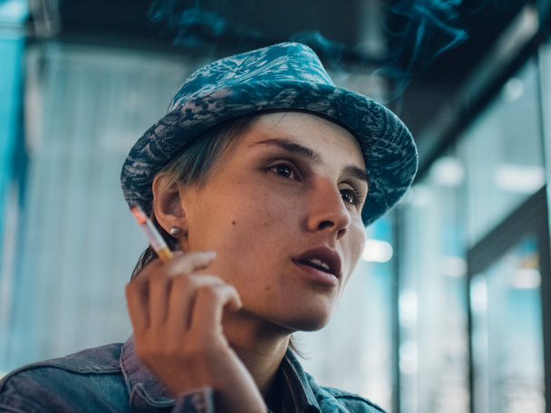 Street portrait of a smoking woman, feeling lonely,sad woman concept - Photo, Image