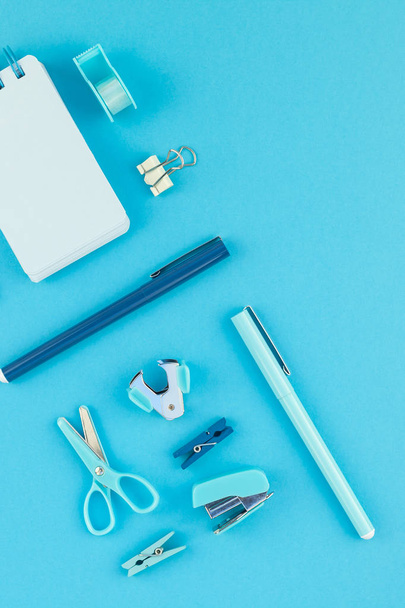 Top view knolling flat lay of workspace desk styled design school and office supplies with copy space turquoise blue color paper background minimal style. Template for feminine blog social media - Foto, afbeelding