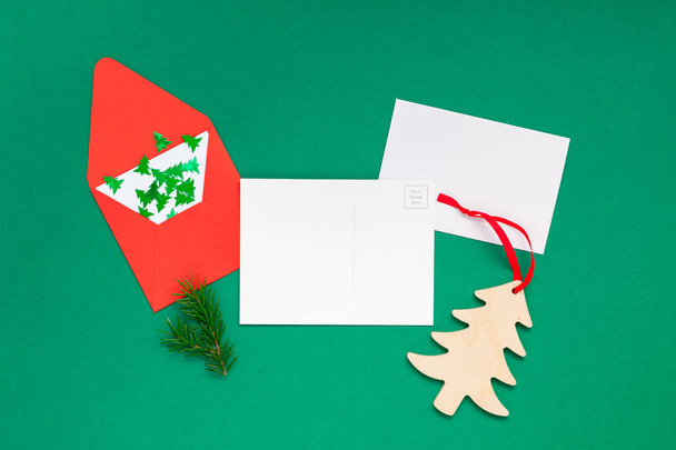 Creative New Year or Christmas greetings letter mockup flat lay top view Xmas holiday celebration envelope on green paper background. Template mock up greeting card or your text design 2019 2020 - Photo, Image