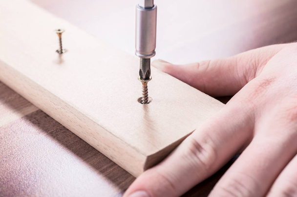 Craftsman Driving A Screw Into A Piece Of Wood - Fotografie, Obrázek