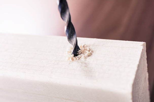 Craftsman Driilling A Hole into A Piece of Wood
 - Фото, изображение