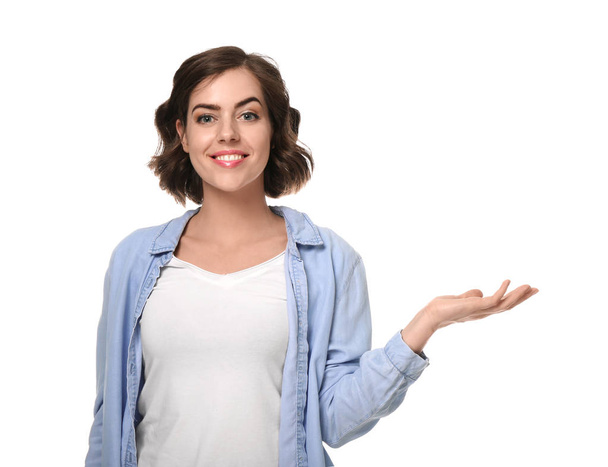 Portrait of beautiful young woman holding something on white background - Photo, Image