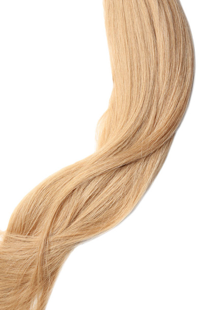 Lock of healthy blond hair on white background - 写真・画像