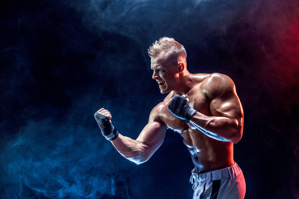 Muscular topless fighter in boxing gloves - Foto, afbeelding