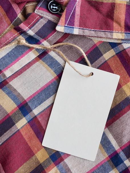 Red, blue, white checkered shirt and  Clothing label - Foto, Imagen