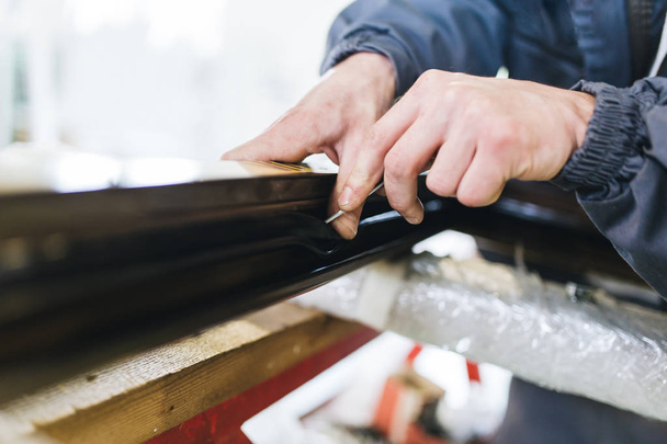 Manual worker cutting aluminum and PVC profiles. Manufacturing jobs. Selective focus. Factory for aluminum and PVC windows and doors production. - 写真・画像