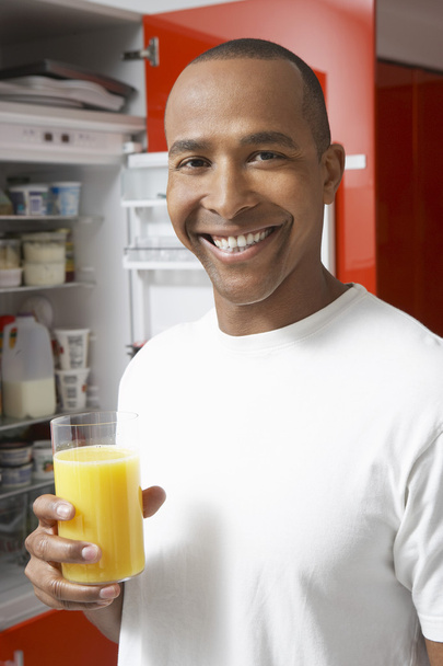 Happy Man Having Fresh Orange Juice - Фото, зображення