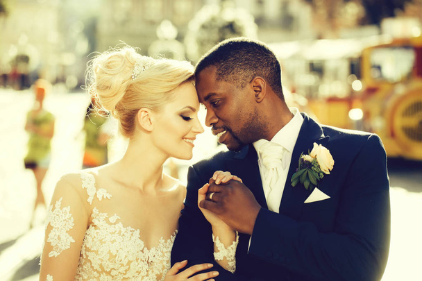 Loving couple of cute bride and african American groom - Photo, Image