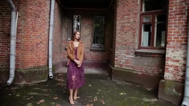 Very beautiful girl posing in the old courtyard of brick houses. - Footage, Video
