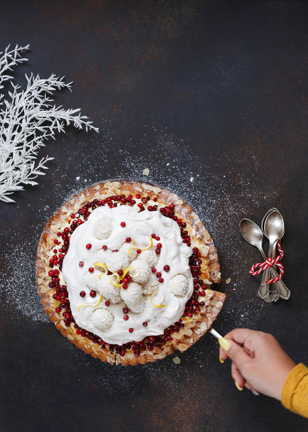 Woman serving holiday cranberry meringue pie. Top view, blank space, dark toned image - Zdjęcie, obraz