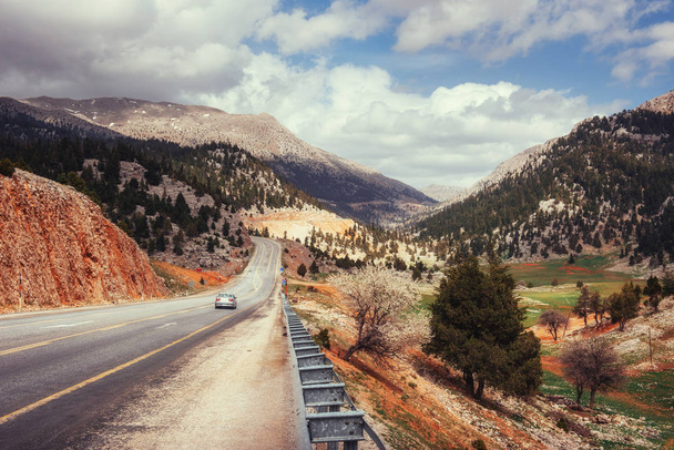 beautiful scenic highway in mountains. Car rides on asphalt surfaces - Photo, Image