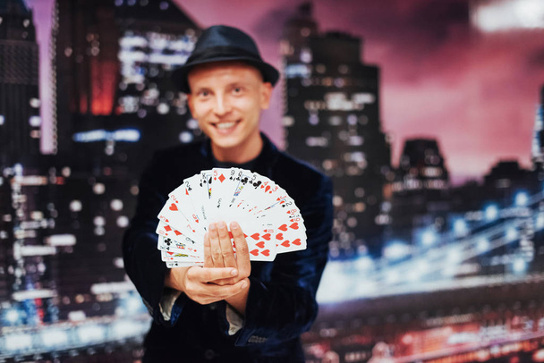 Magician showing trick with playing cards. Magic circus gambling - Фото, изображение