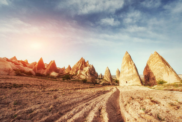 Fantastic sunrise over the Red Valley in Cappadocia, Anatolia, Turkey. Volcanic mountains in Goreme National Park. - Photo, image