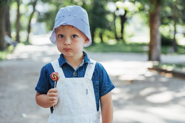 young boy with colorful lollipop. Ukraine. Europe - Φωτογραφία, εικόνα