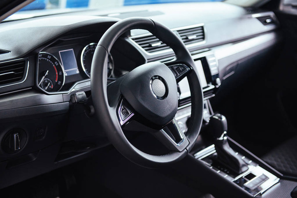 Modern car interior dashboard and steering wheel. - Фото, зображення