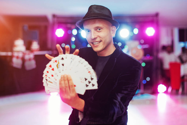 Magician showing trick with playing cards. Magic circus gambling - Фото, зображення