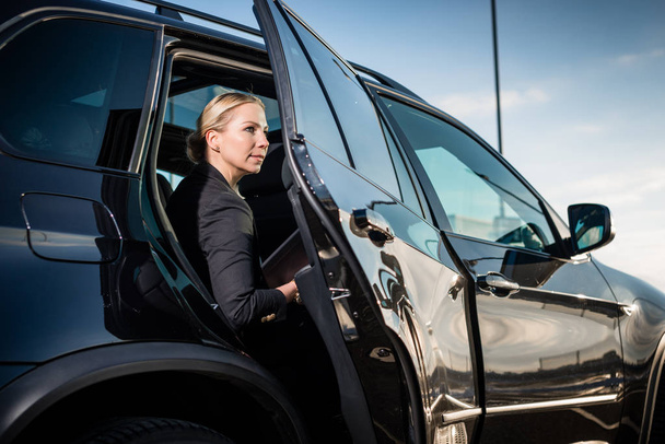Businesswoman sitting in car - Фото, изображение