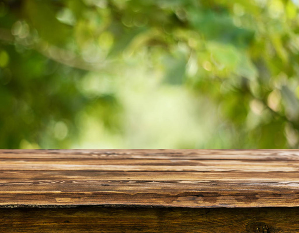 Empty wooden table with blurred natural background - Photo, Image