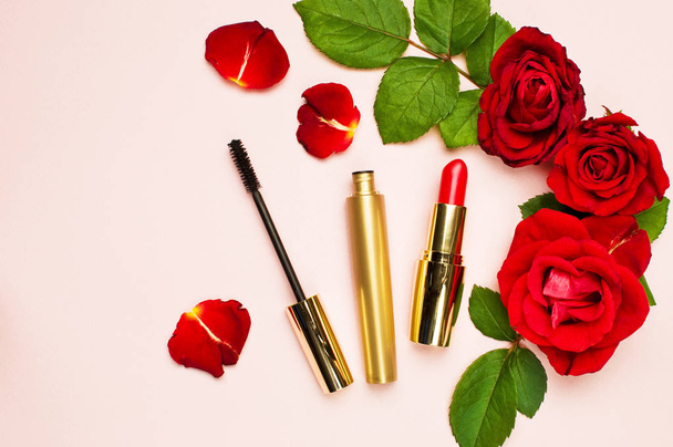 Various makeup products with red roses on a pink background with copy space top view Flat Lay Women's things - Photo, Image