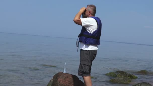 Redder aan zee kijkt de verrekijker  - Video