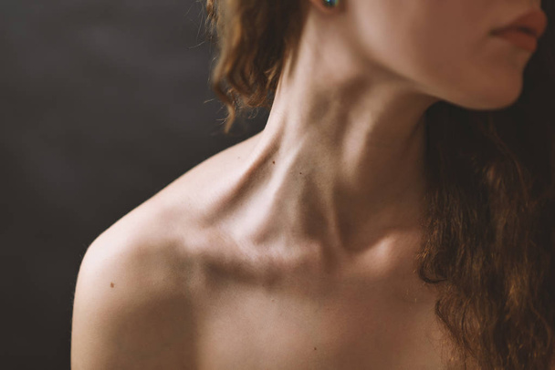 Girl's neck wtih dramatic light. - Valokuva, kuva