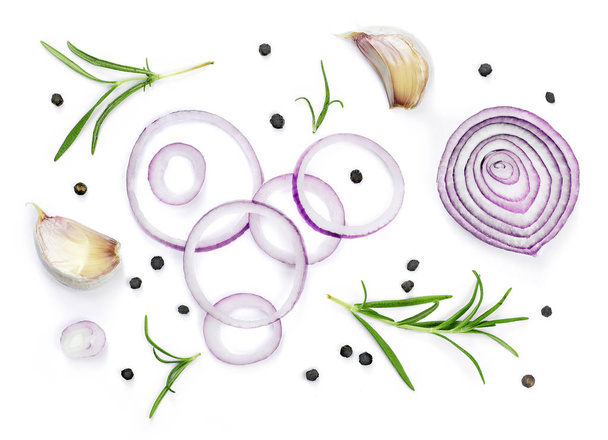 Beautiful fresh red onions, spices and herbs. Group of objects or cooking ingredients, isolated on white background. Closeup shot, top view. - Photo, Image