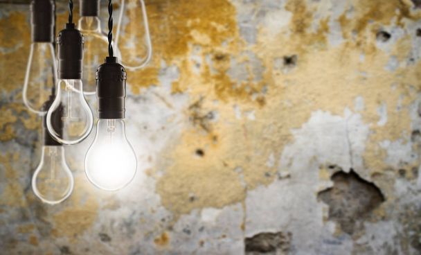 Idea and leadership concept - Vintage bulbs on the grunge background - Photo, Image